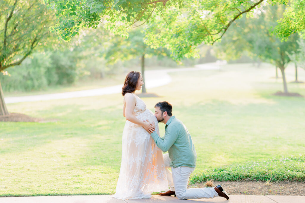 dad kisses mom's baby bump at rob fleming park for Cypress Maternity Photographer allie nichols photography