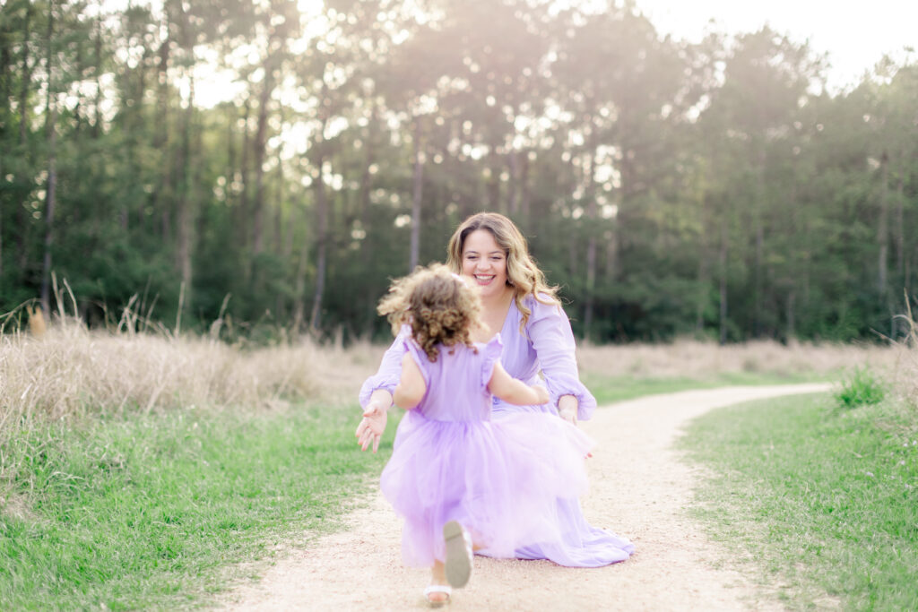 Little girl runs to mom in an open field in kingwood, texas